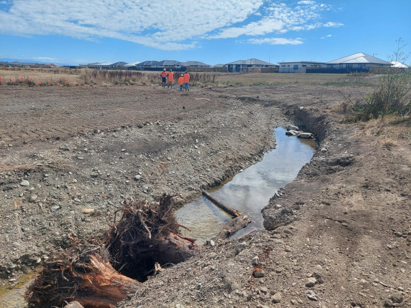 low flow channel which has woody debris and steep sided pools excavated below the summer water table for fish refuge